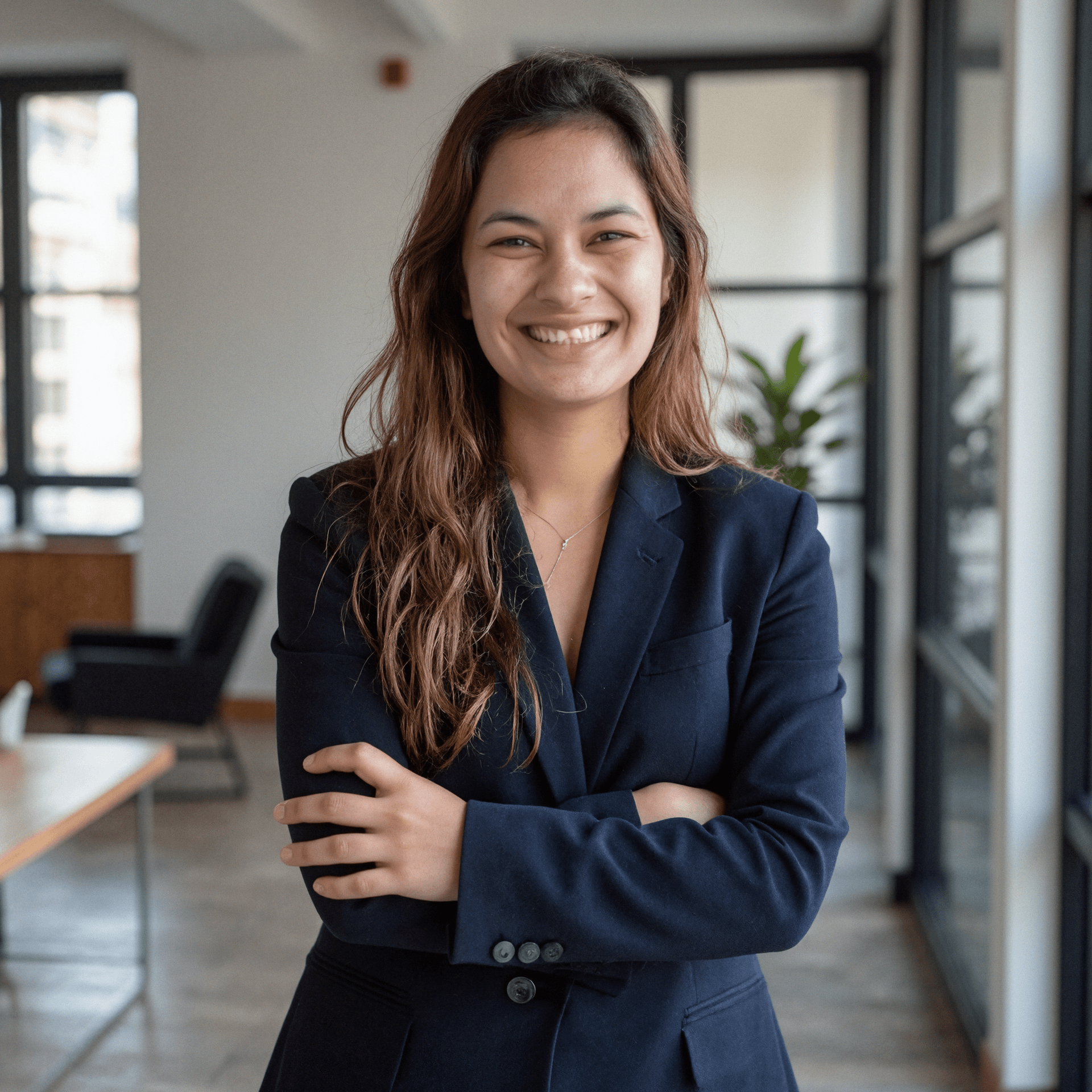 Me wearing a dark blazer in front of a modern building